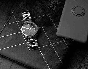 A flat lay image featuring a JDM Military Sapphire watch, by Seb Duper.