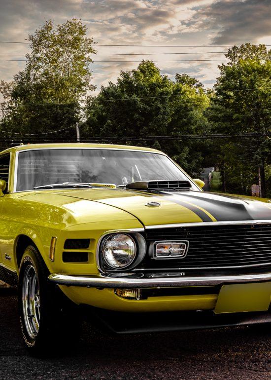 Front 3/4 photo of a yellow 1970 Mustang Mach I, by Seb Duper