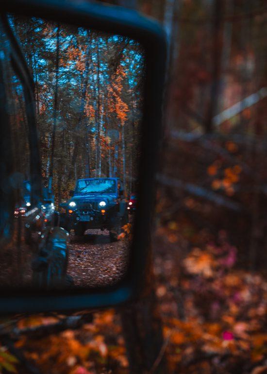 Photo of a Jeep Wrangler shot in the side mirror of another Jeep