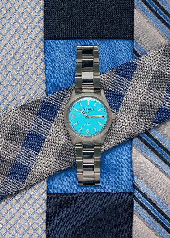 Product photographer Seb Duper created this lifestyle photo of the Matthey Tissot 369 Tiffany Blue watch laid on colourful men's ties
