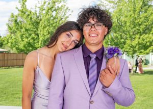 A young woman and a young man, both high school seniors, pose for an exterior portrait during a HS graduation ceremony in Ottawa.