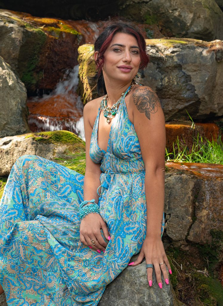 Portrait of a young business woman sitting on a rock in front of a cascade. Shot at Andrew Hayden Park, in Ottawa, by Seb Duper