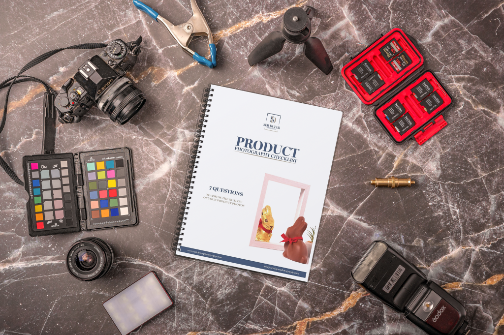 Checklist Ebook flat lay A flat lay composition with photography gear surrounding a coiled book.