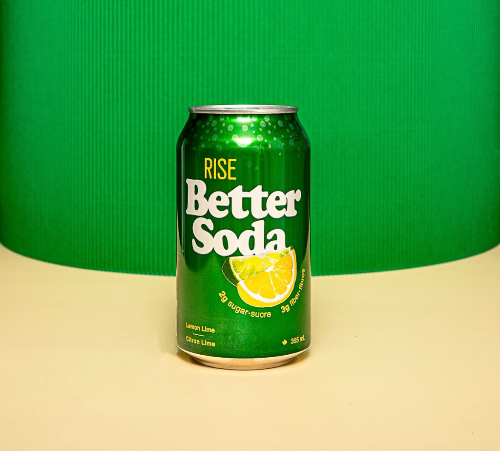 A green can of soda pop on a lemon yellow and green background